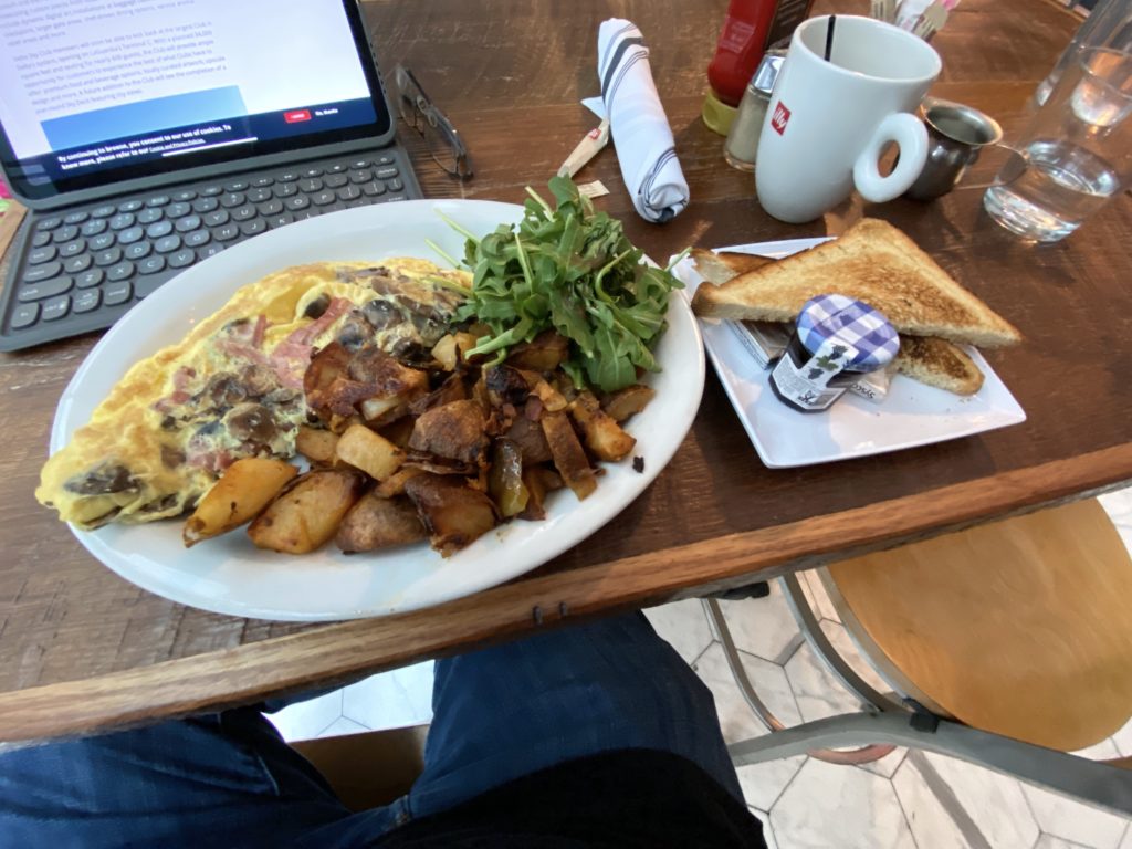Omelette, potatoes, salad, and toast at Burgerology in New York