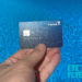 The Capital One Venture X Rewards Credit Card set against a swimming pool.