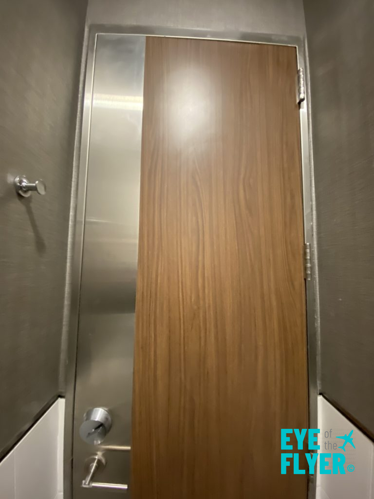 a wood door in a bathroom