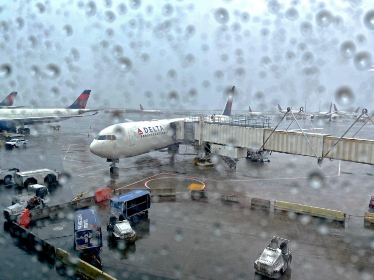 A Delta Air Lines 767-400 experiences bad weather at New York-Kennedy Airport (JFK): thunderstorms and rain.