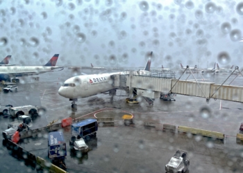 A Delta Air Lines 767-400 experiences bad weather at New York-Kennedy Airport (JFK): thunderstorms and rain.