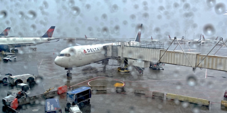 A Delta Air Lines 767-400 experiences bad weather at New York-Kennedy Airport (JFK): thunderstorms and rain.