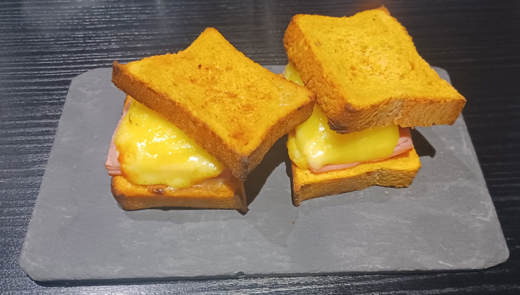 a sandwich with ham and cheese