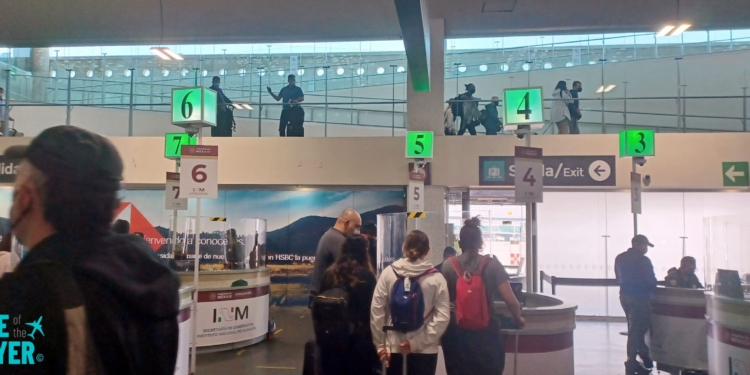 people standing in a line at an airport