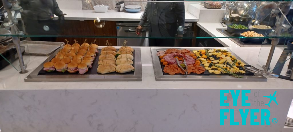 a buffet table with different sandwiches and meats