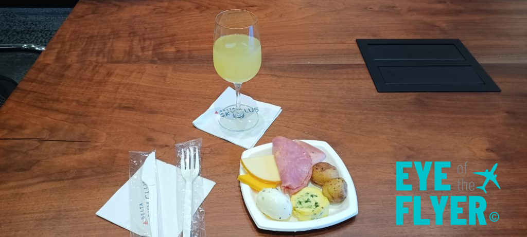 a plate of food and a glass of juice on a table