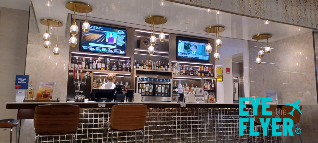 a bar with a counter and tvs