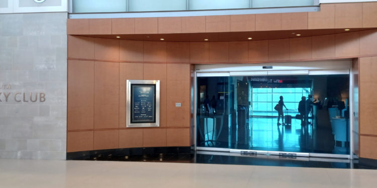 a glass door with a sign in the middle of a building