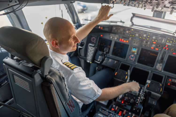 An airline pilot sits in the cockpit