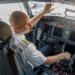 An airline pilot sits in the cockpit