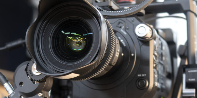 Professional digital video camera lens, studio recording equipment on details close up.