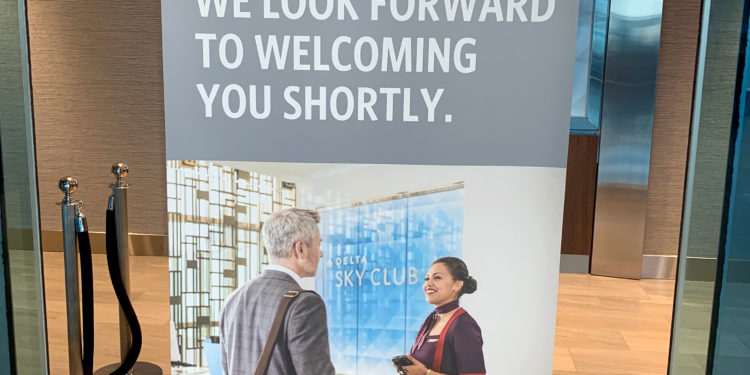 A Delta Sky Club airport lounge in Detroit displays a sign telling guests that the location is at capacity.
