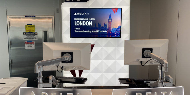 a room with white chairs and a large screen