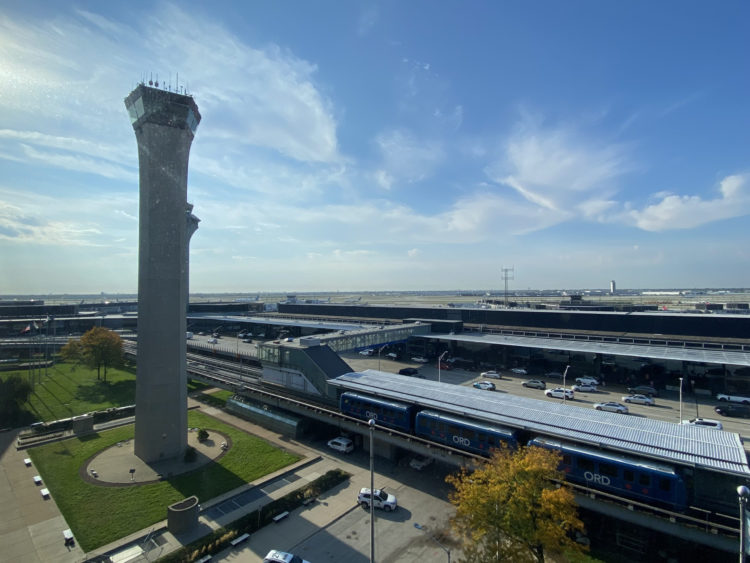 a train station with a tower and a train