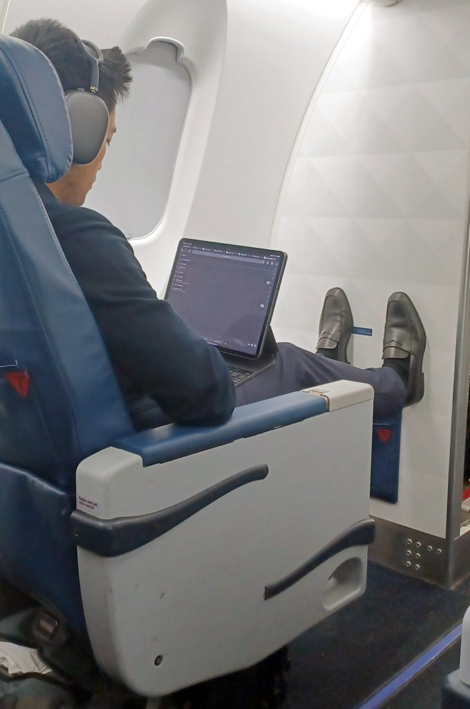 a man sitting in a chair with a laptop