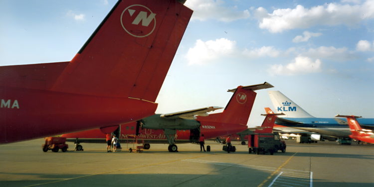 a group of red airplanes on a runway