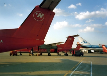 a group of red airplanes on a runway