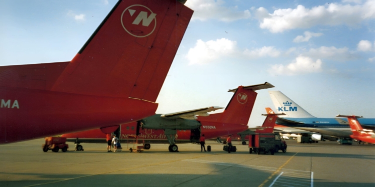 a group of red airplanes on a runway