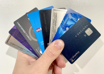 a hand holding a group of credit cards