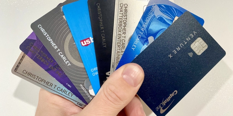 a hand holding a group of credit cards