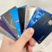 a hand holding a group of credit cards