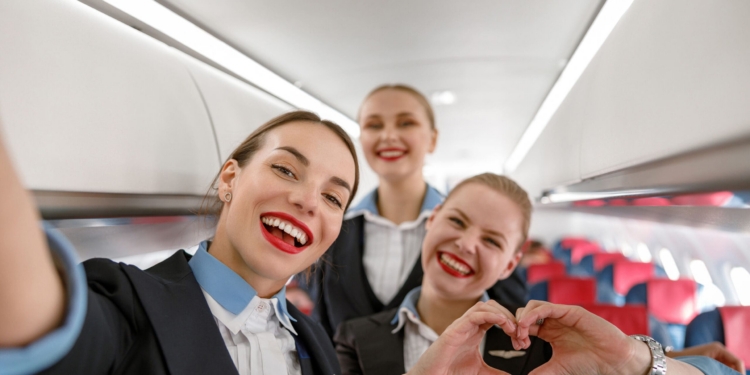 Flight attendants smiling for a selfie photo