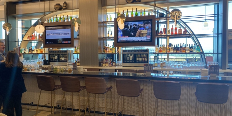 a bar with a television and chairs