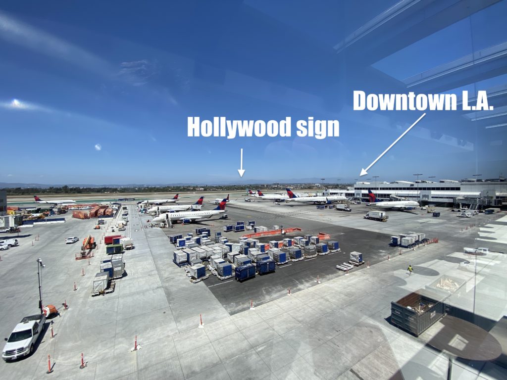 an airport with airplanes and a sign