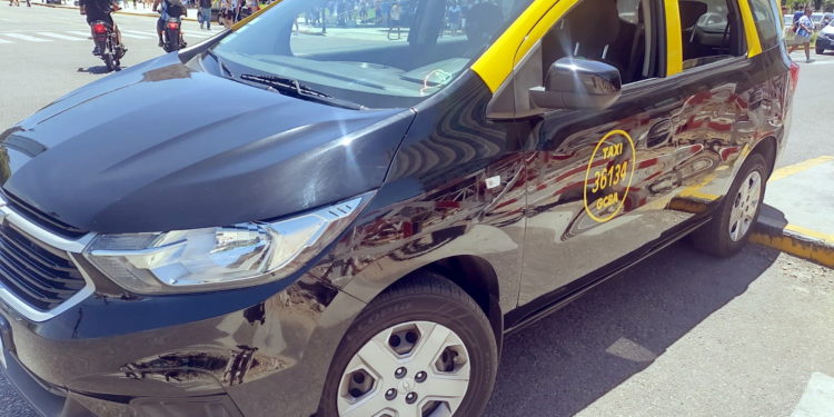 a black and yellow car on a street
