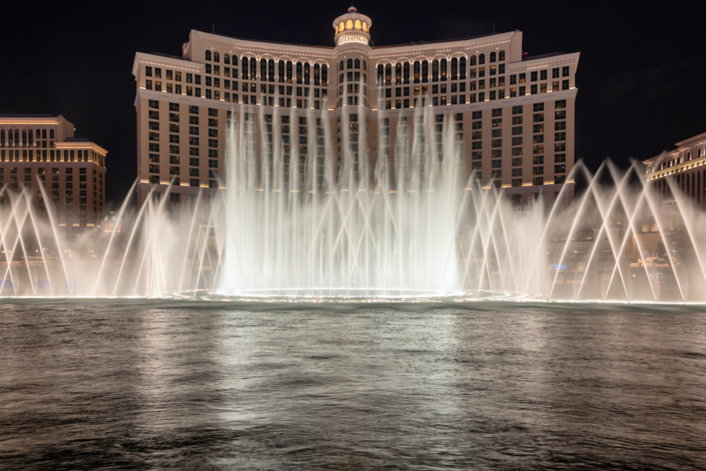 Las Vegas, USA - July 26, 2018: Bellagio Hotel and Casino and Bellagio fountain show as seen at night on July 26, 2018 in Las Vegas, Nevada. Las Vegas is one of the top tourist destinations in the world.