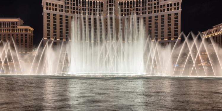 Las Vegas, USA - July 26, 2018: Bellagio Hotel and Casino and Bellagio fountain show as seen at night on July 26, 2018 in Las Vegas, Nevada. Las Vegas is one of the top tourist destinations in the world.