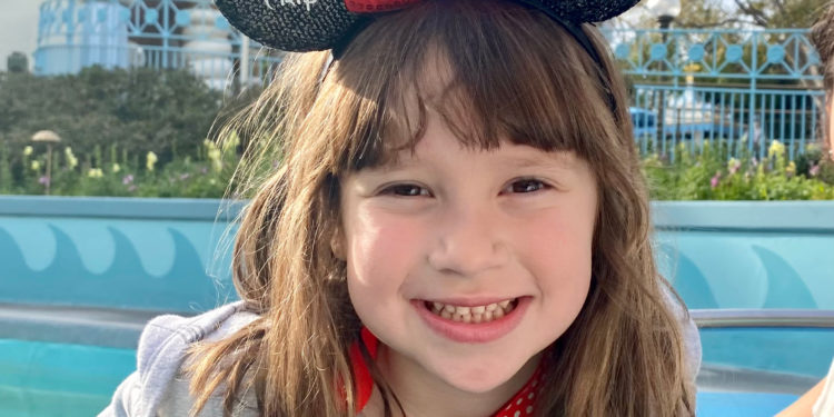 A little girl rides on "It's a Small World" during her first Disneyland visit.
