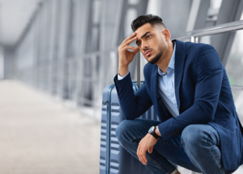 A nervous, anxious traveler at an airport. Flight delay.