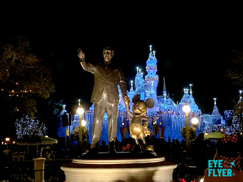 A statue of a Walt Disney and Mickey Mouse in front of Cinderella's Castle at Disneyland in Anaheim, California.