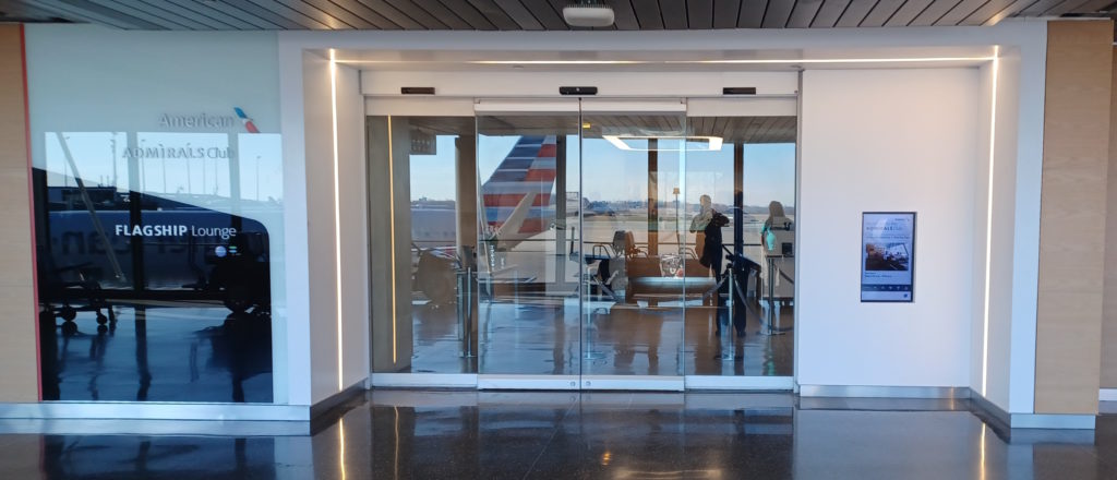 a glass door with a plane in the background