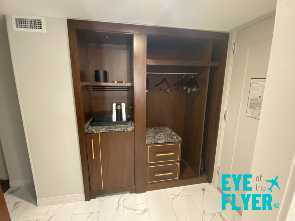 a closet with a marble counter top and a shelf with swingers