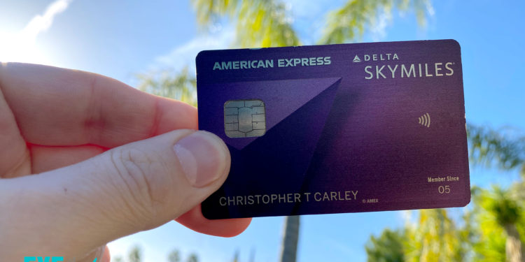 a hand holding a credit card