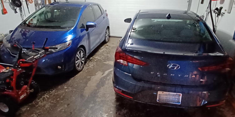 a blue car parked next to a blue car