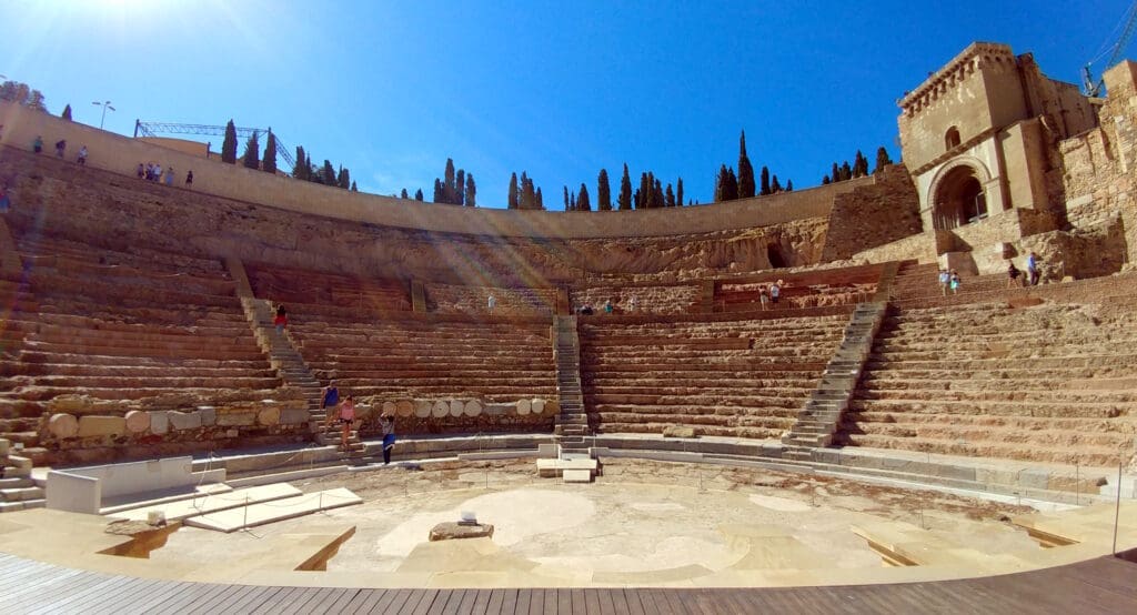 a large stone amphitheater with people standing around