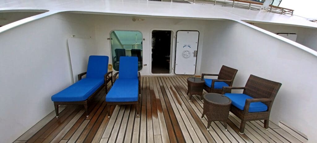 a deck with chairs and tables on it