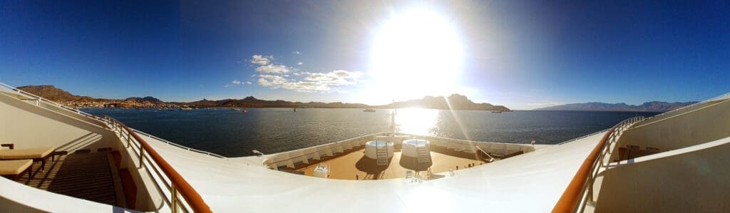 a deck of a cruise ship with a hot tub on the water