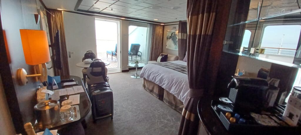 a room with a bed and luggage