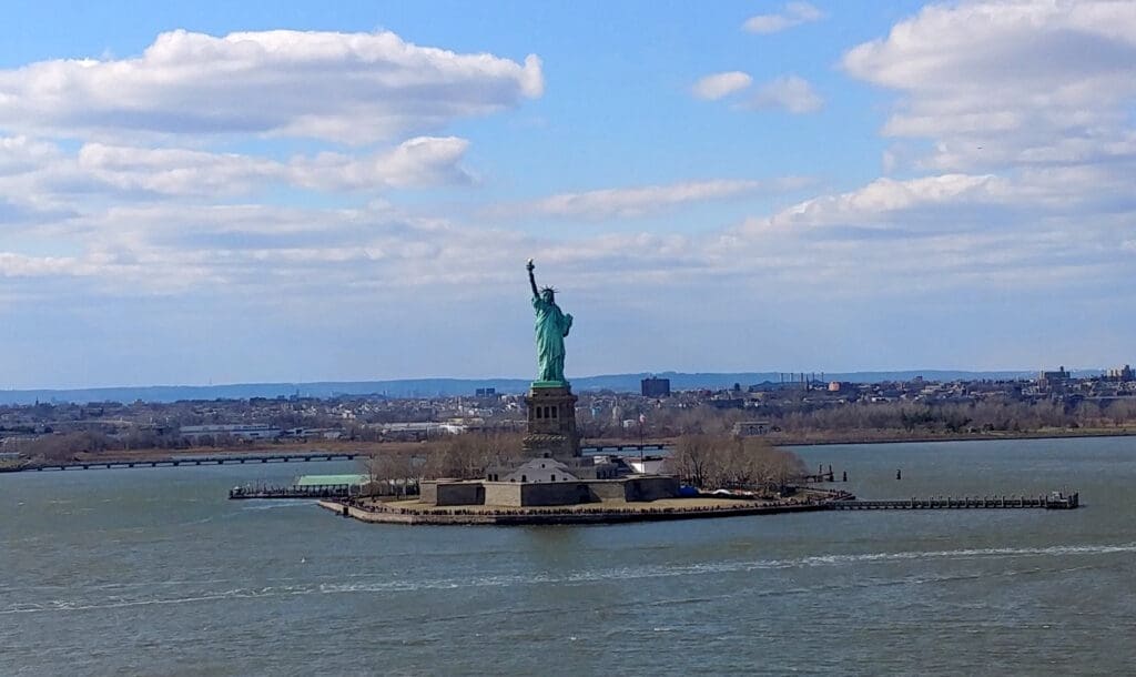 a statue of liberty on an island in the middle of water