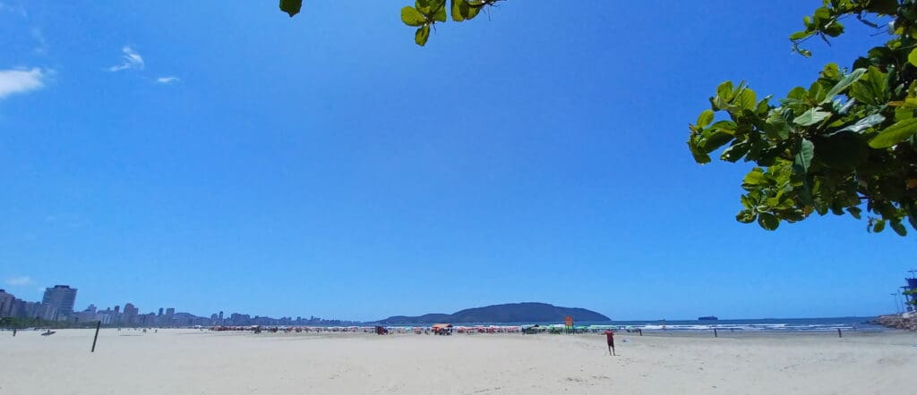 a beach with people walking on it