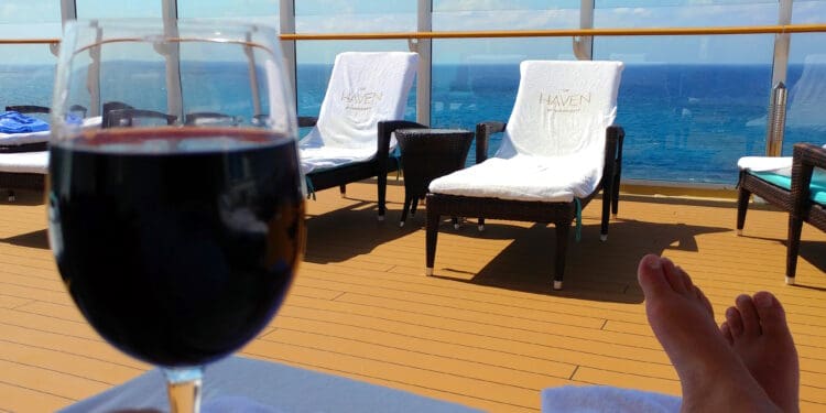 a glass of wine on a deck