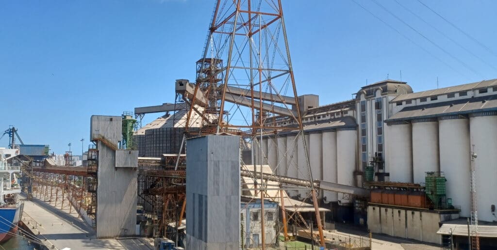 a large metal tower next to a building