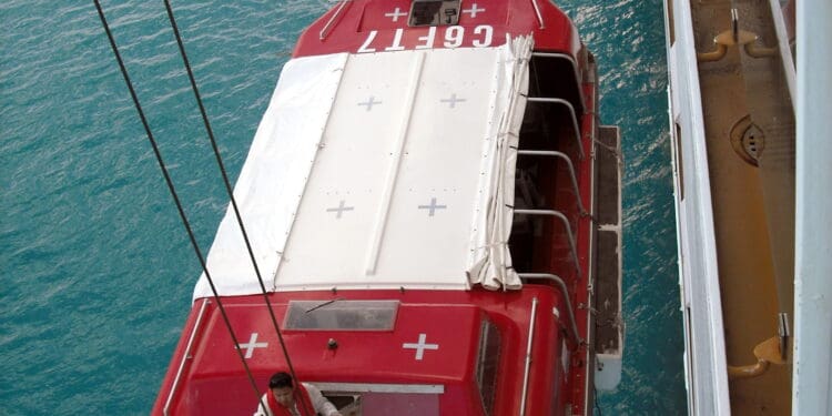 a red and white boat on a bridge over water