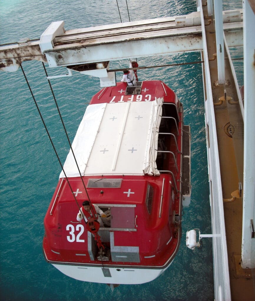 a red and white boat on a bridge over water