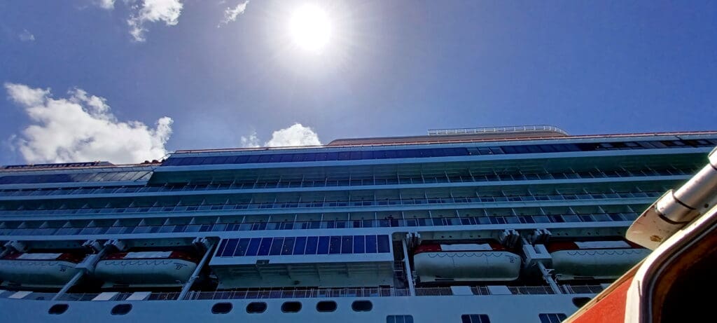 a large cruise ship with a boat on the deck