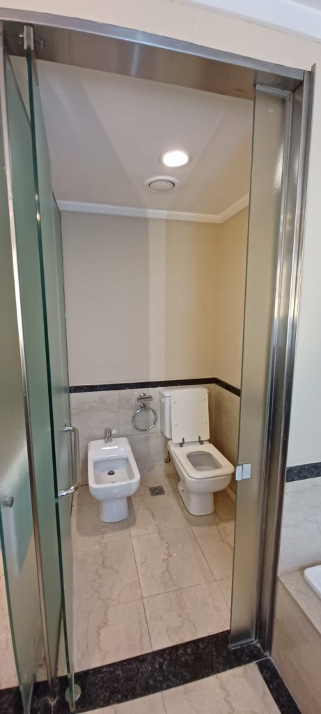 a bathroom with a toilet and bidet